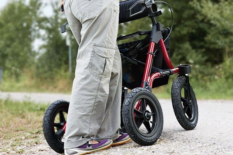 legs-of-person-pushing-the-Electric-Mobility-TAiMA-XC-Rollator