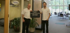 Mobility-Aids-Centre-staff-holding-welcome-sign-at-NuStep-HQ
